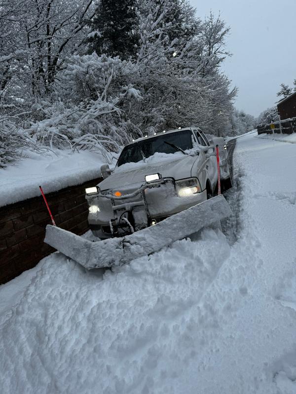 Clear Landscaping plough truck working a commercial site while snow is still falling